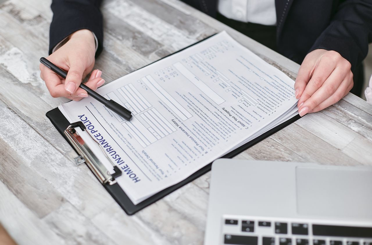 Hands reviewing a home insurance policy