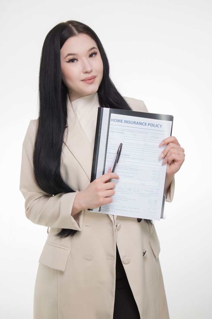 team-03 Professional businesswoman presenting a home insurance policy with confidence.